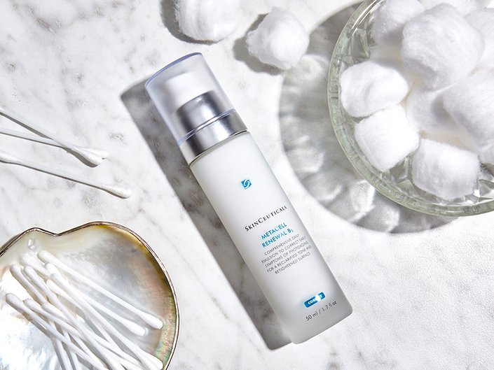 SkinCeuticals Metacell Renewal B3 lying on a bathroom countertop with cotton swabs and cotton balls